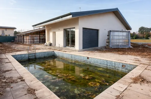 Aerial view of the initial excavation and structural block wall reinforcement for a new residential pool in Los Angeles