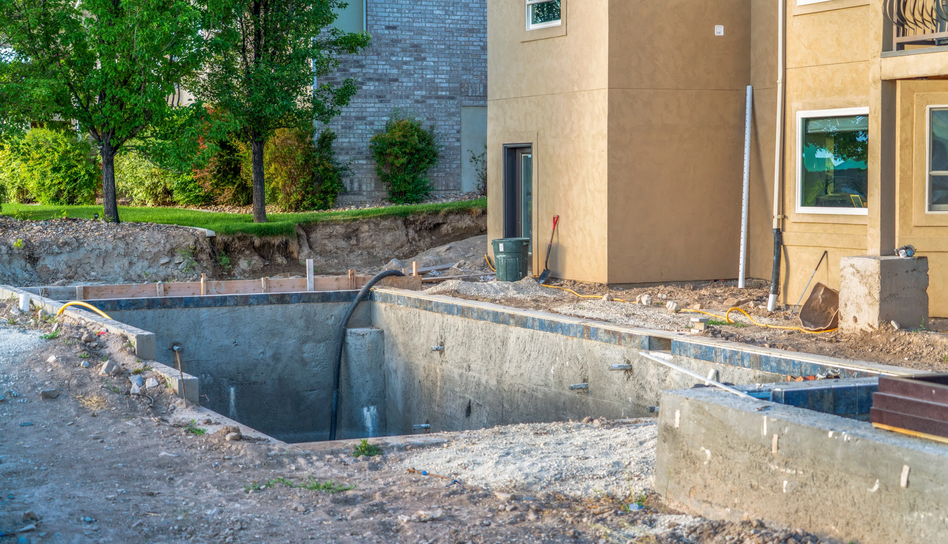 Structural gunite and block phase of a new residential pool installation following Los Angeles building safety codes.