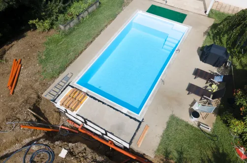 Professional pool contractor installing high-efficiency plumbing lines and filtration equipment for a smart pool system.