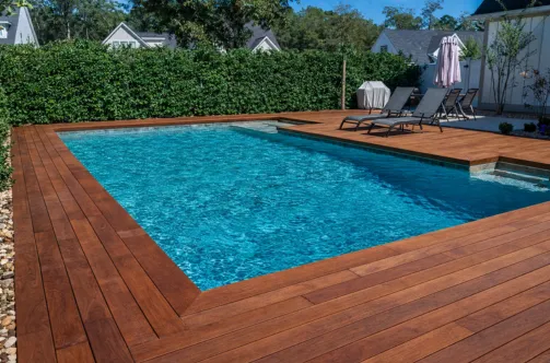 New custom pool with premium blue tile finish being filled for the first time after successful construction.